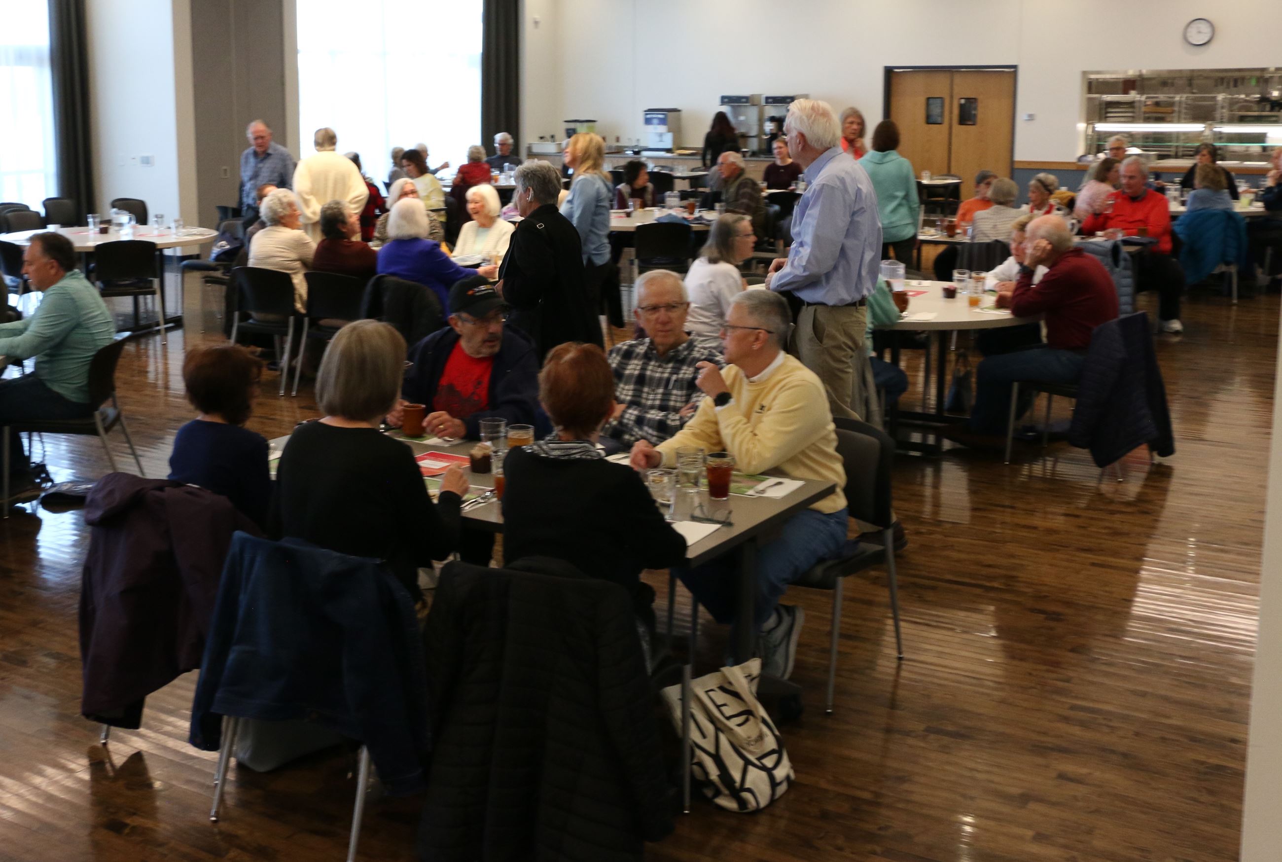 People enjoying lunch, sitting at tables at the Lakeshore Cafe.