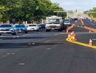 City striper truck with traffic signals and cones.