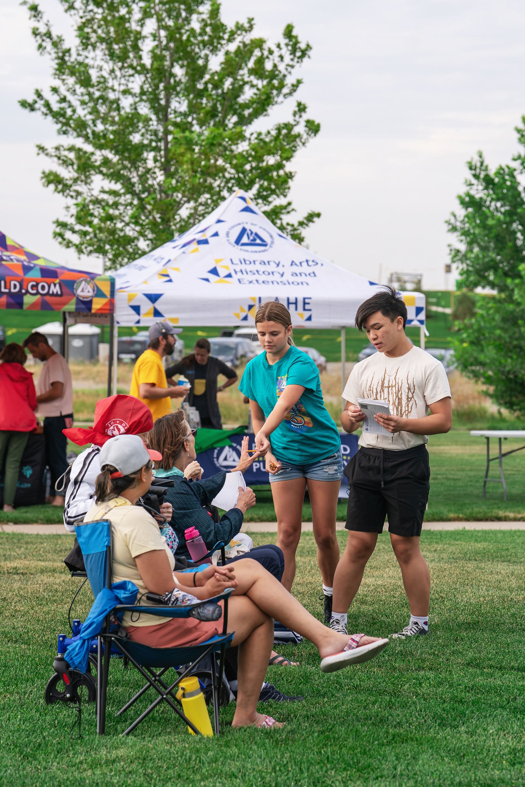 photo of volunteers handing out surveys at the summer concert
